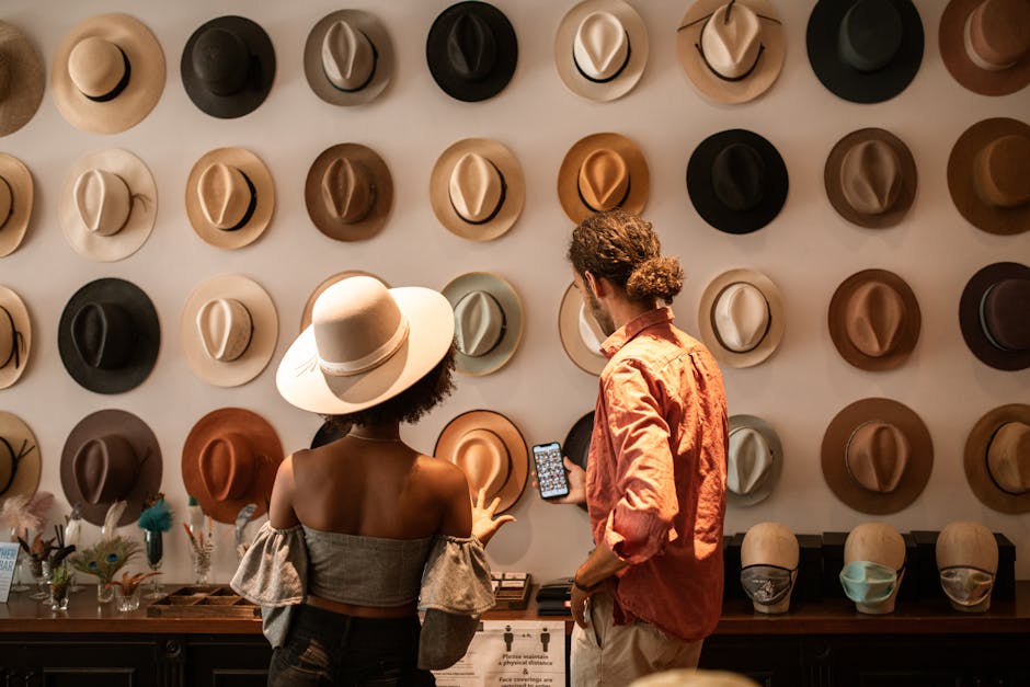 A stylish couple exploring a hat boutique, showcasing diverse headwear.