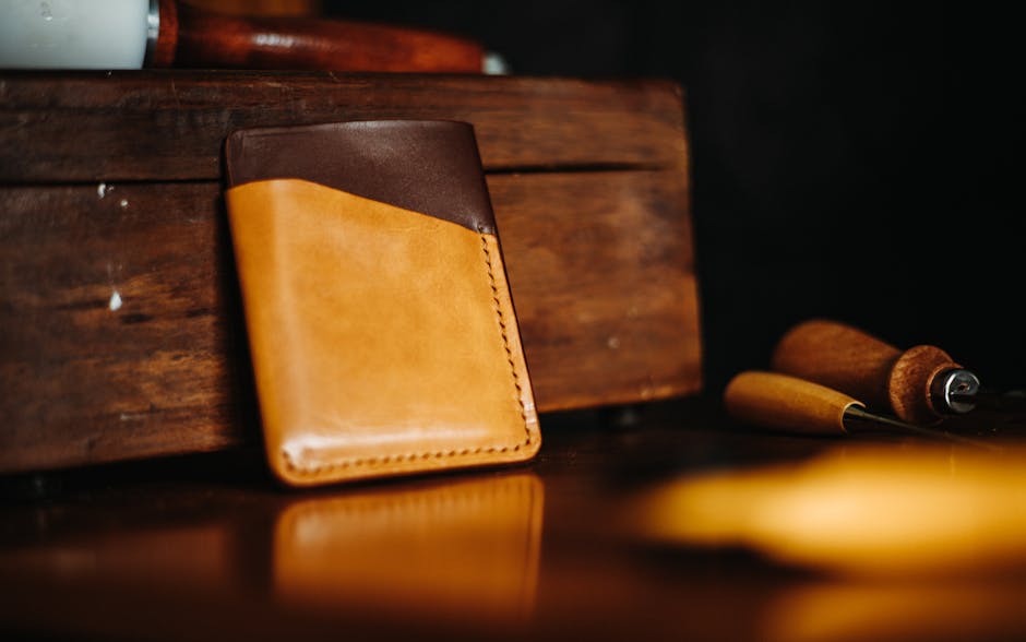 Stylish brown and tan leather wallet against a rustic wooden backdrop, perfect for showcasing craftsmanship.