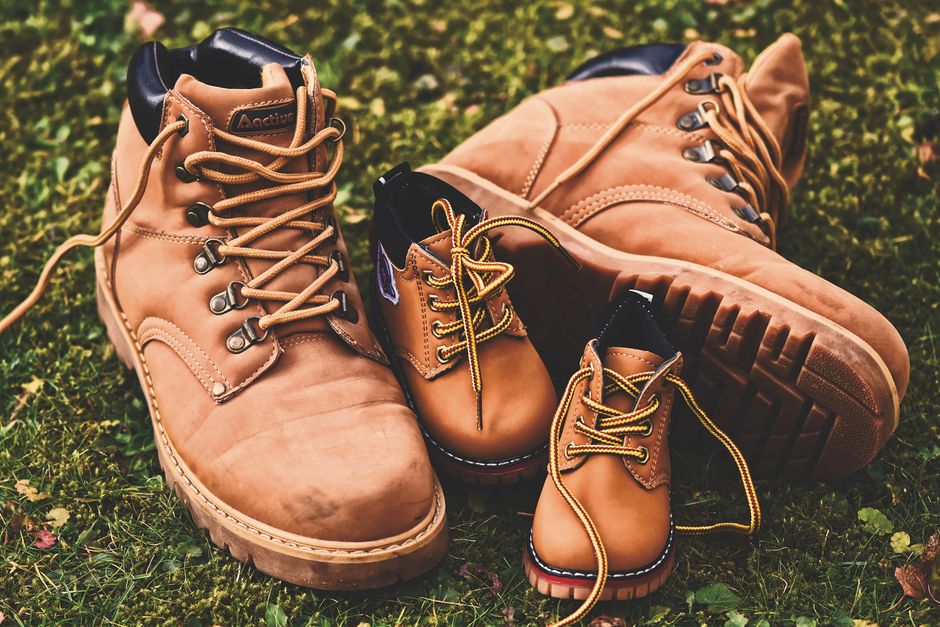 Brown leather shoes with laces and stylish design on grass, suitable for fashion concept.