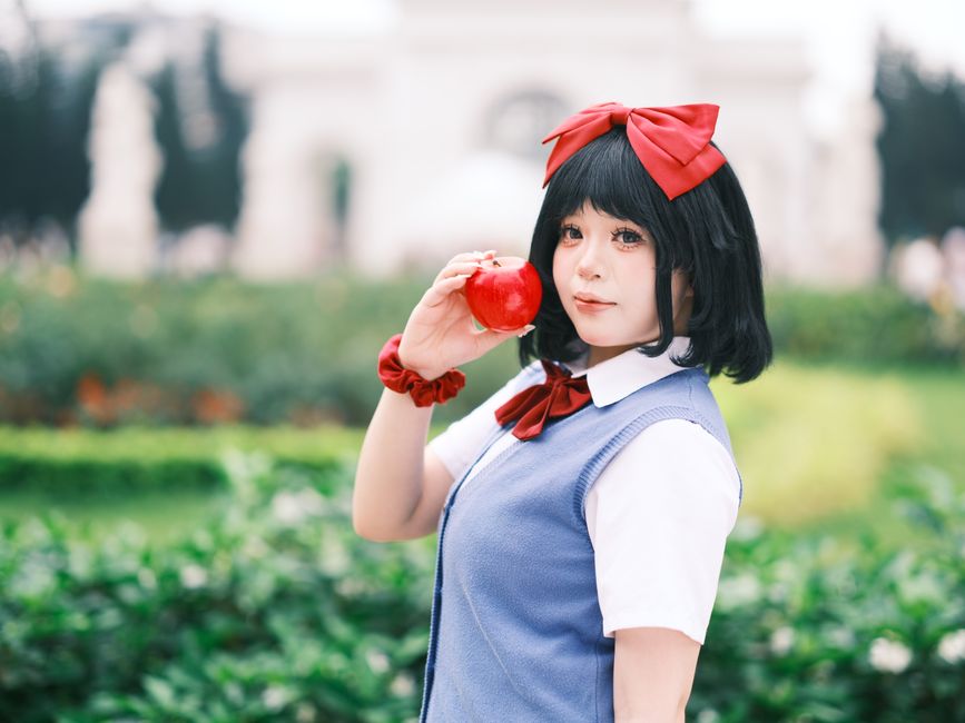 A vibrant cosplay portrait taken outdoors in a lush Vietnamese garden, showcasing creativity and style.